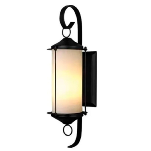 Esta arandela colonial tem um design alongado e elegante. No centro, um cilindro de vidro fosco emite uma luz suave e amarelada. A estrutura é de metal preto, com hastes finas e curvas decorativas em formato de "S" no topo e na base, conferindo um estilo clássico e sofisticado.