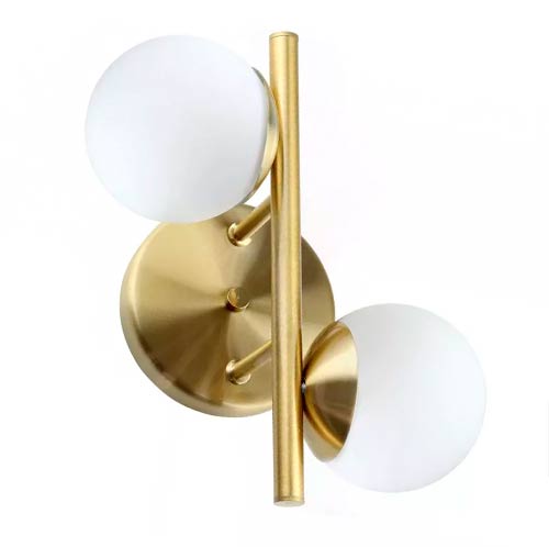Esta arandela dourada tem uma base circular de onde saem duas pequenas hastes que seguram uma barra vertical central. Presos a essa barra, há dois globos de vidro branco fosco em alturas diferentes, um para cada lado. O design é elegante, moderno e cria um equilíbrio assimétrico refinado.