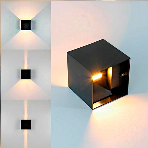 
Esta arandela é um cubo preto fosco que permite ajustar o foco da luz. Ela projeta feixes luminosos para cima e para baixo, cujos ângulos podem ser alterados para criar desde linhas finas até triângulos largos de luz na parede, oferecendo um efeito decorativo dinâmico e moderno.