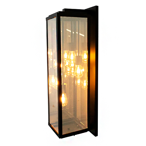 
Esta arandela retangular vertical possui estrutura preta e faces de vidro transparente, assemelhando-se a uma lanterna moderna. Em seu interior, há quatro lâmpadas de filamento que emitem uma luz quente e amarelada, criando um efeito decorativo elegante para paredes e fachadas.
